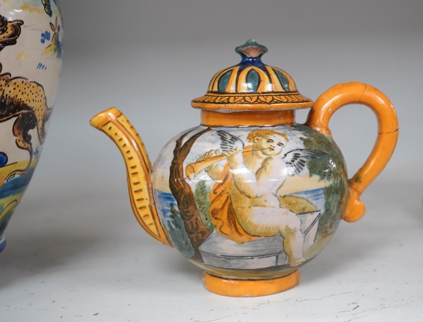 An Italian maiolica teapot and jug and a Talavera maiolica vase, 25cm high (3). Condition - jar good, teapot restored and cracked